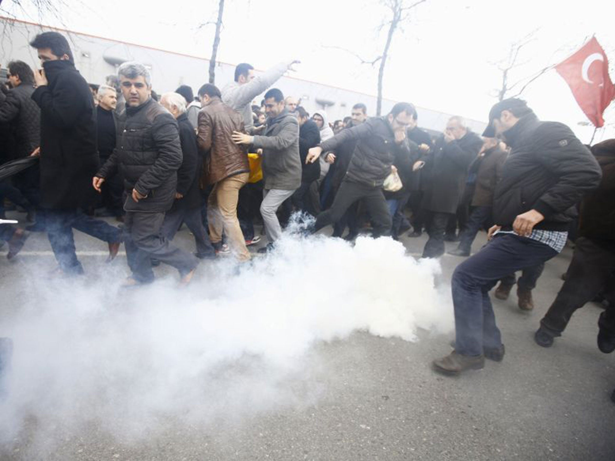 Riot police use tear gas to disperse protesting employees and supporters of Zaman newspaper at the courtyard of the newspaper's office in Istanbul, Turkey.