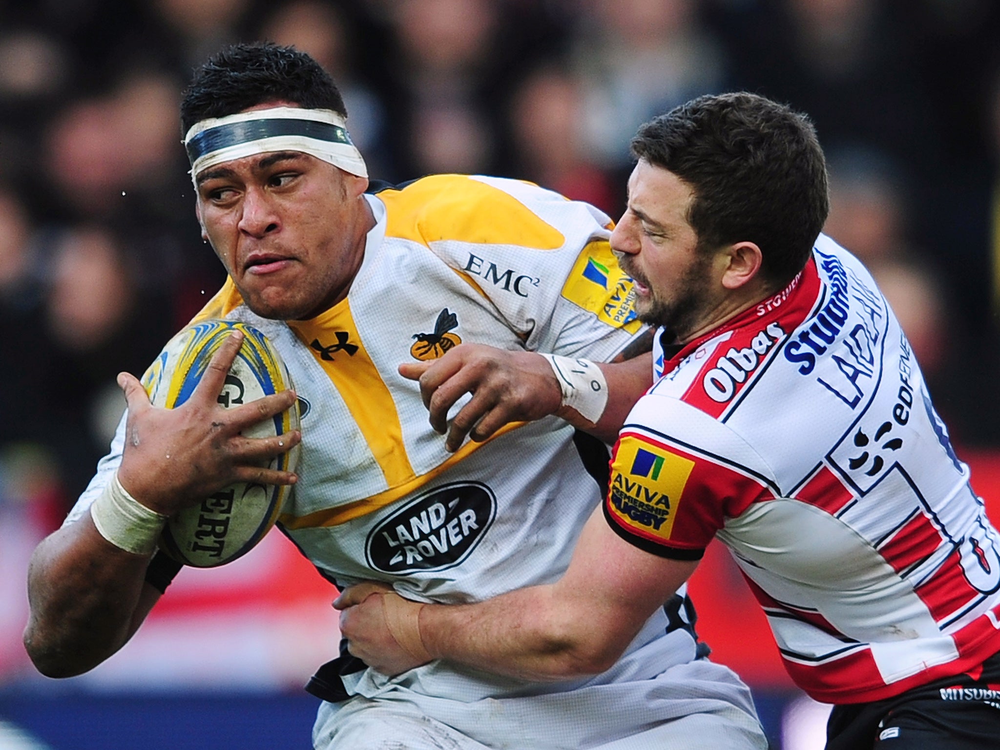 Nathan Hughes of Wasps is tackled by Greig Laidlaw of Gloucester