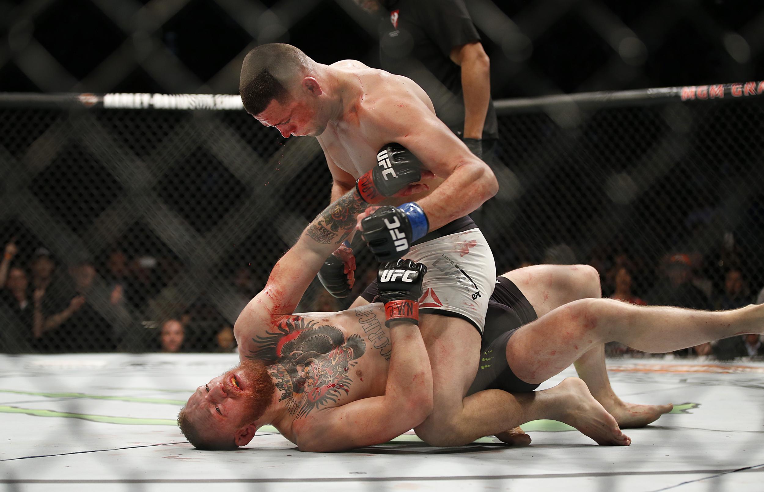 Nate Diaz, top, trades punches with Conor McGregor