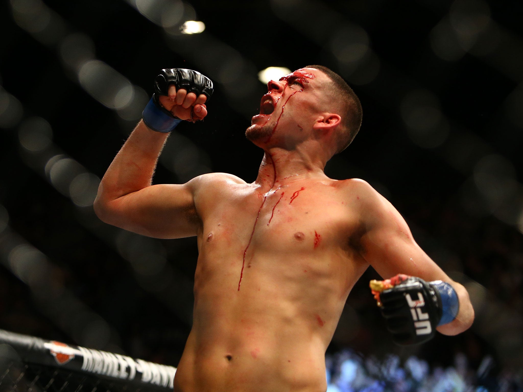 Nate Diaz celebrates victory over Conor McGregor by submission at UFC 196