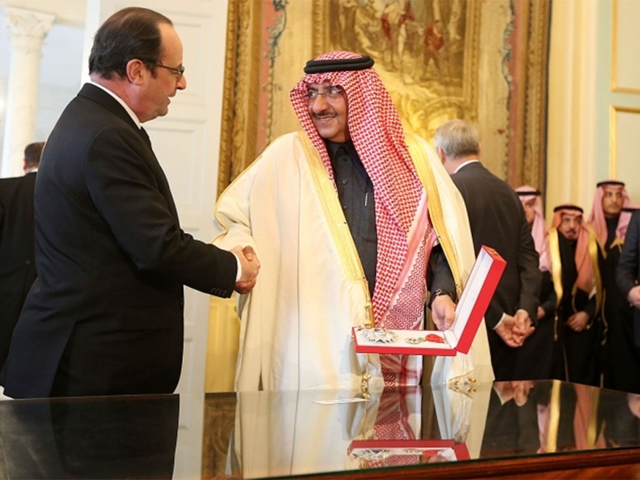 President Francois Hollande hands Crown Prince Mohammed bin Naif the Legion d'Honneur, France's highest honour, at a low-key ceremony in Paris on 4 March 2016
