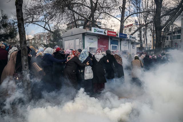 Turkish riot police deploy tear gas against protesters outside the offices of bestselling daily newspaper ‘Zaman’