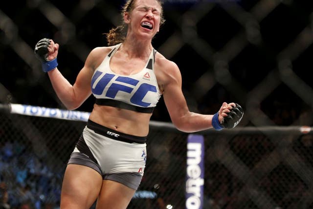 Miesha Tate celebrates her victory over Holly Holm at UFC 196