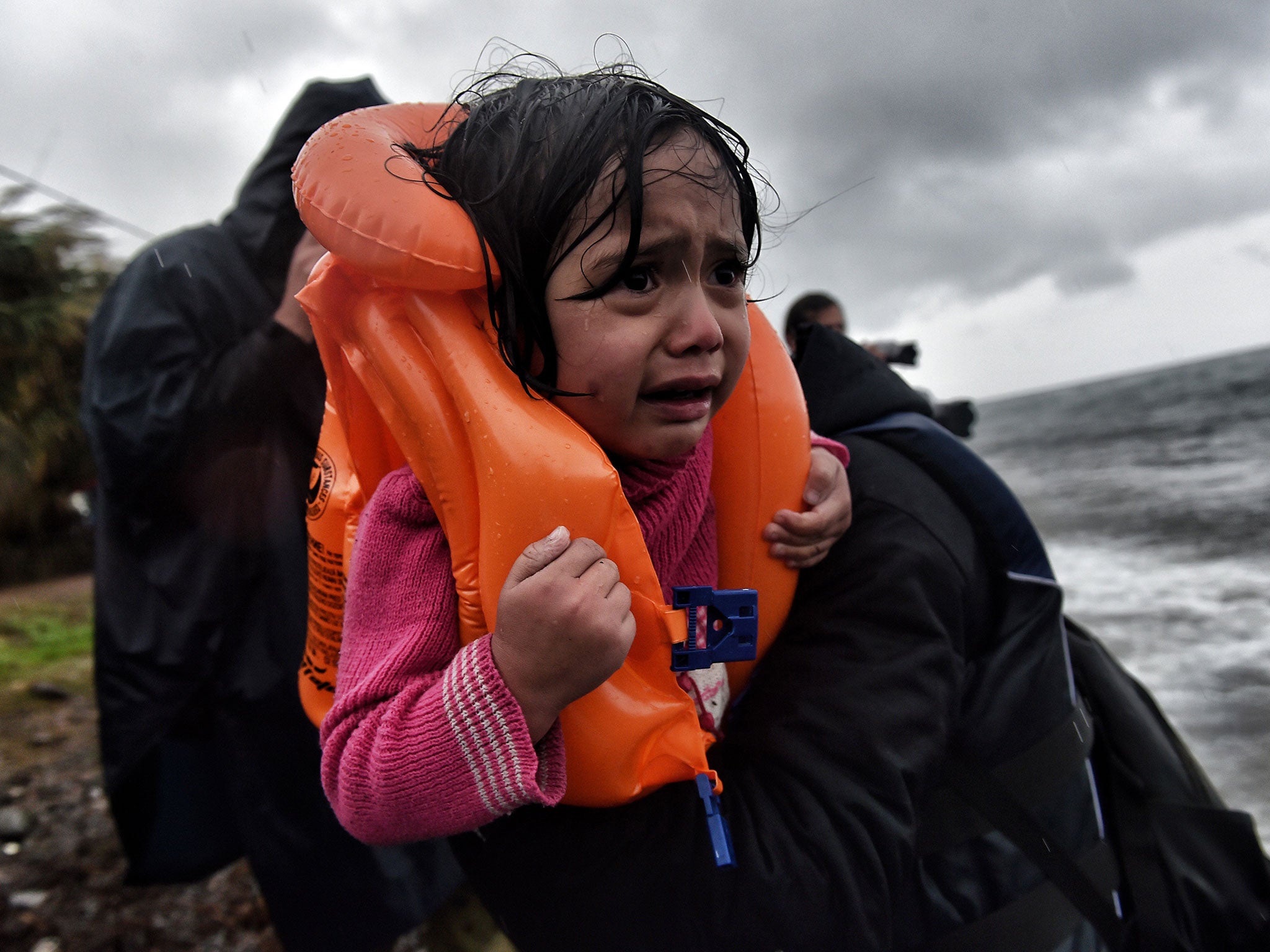 Refugees and migrants arrive at Lesbos island after crossing the Aegean sea from Turkey on 23 October 2015