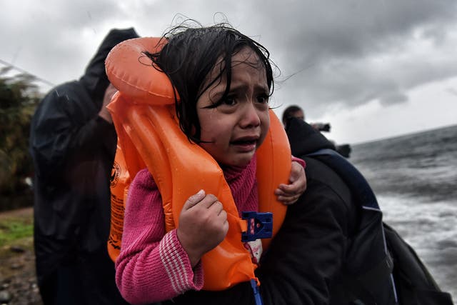Refugees and migrants arrive at Lesbos island after crossing the Aegean sea from Turkey on 23 October 2015