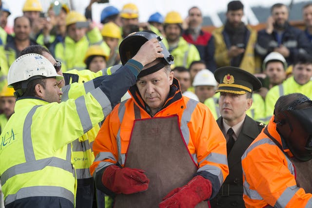 Turkey's President Tayyip Erdogan prepares for the welding of the final section of the Yavuz Sultan Selim Bridge, the Third Bosphorus Bridge, during a ceremony in Istanbul, Turkey