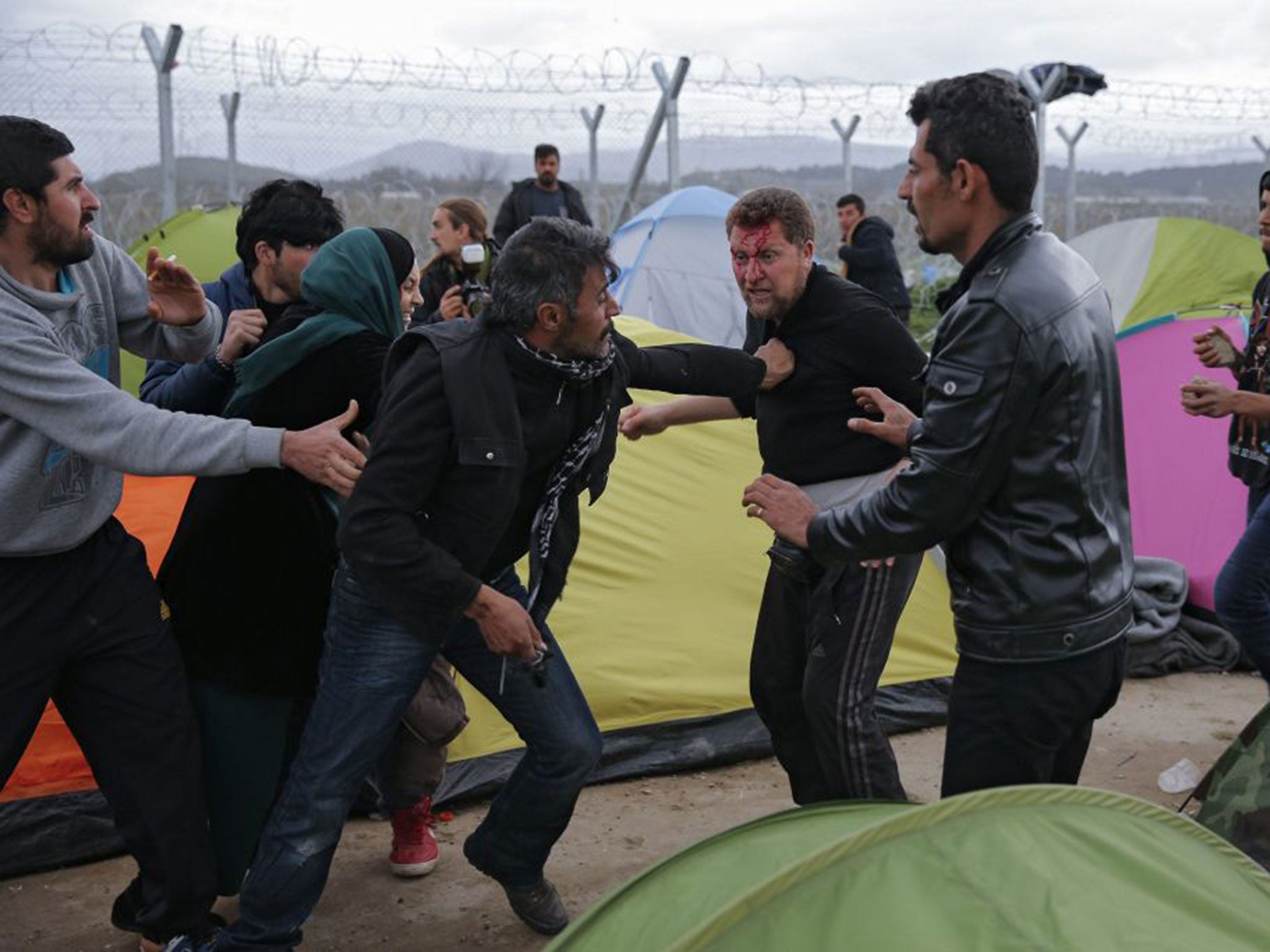 A fight breaks out between refugees in a camp at the Greek-Macedonian border near Idomeni, Greece