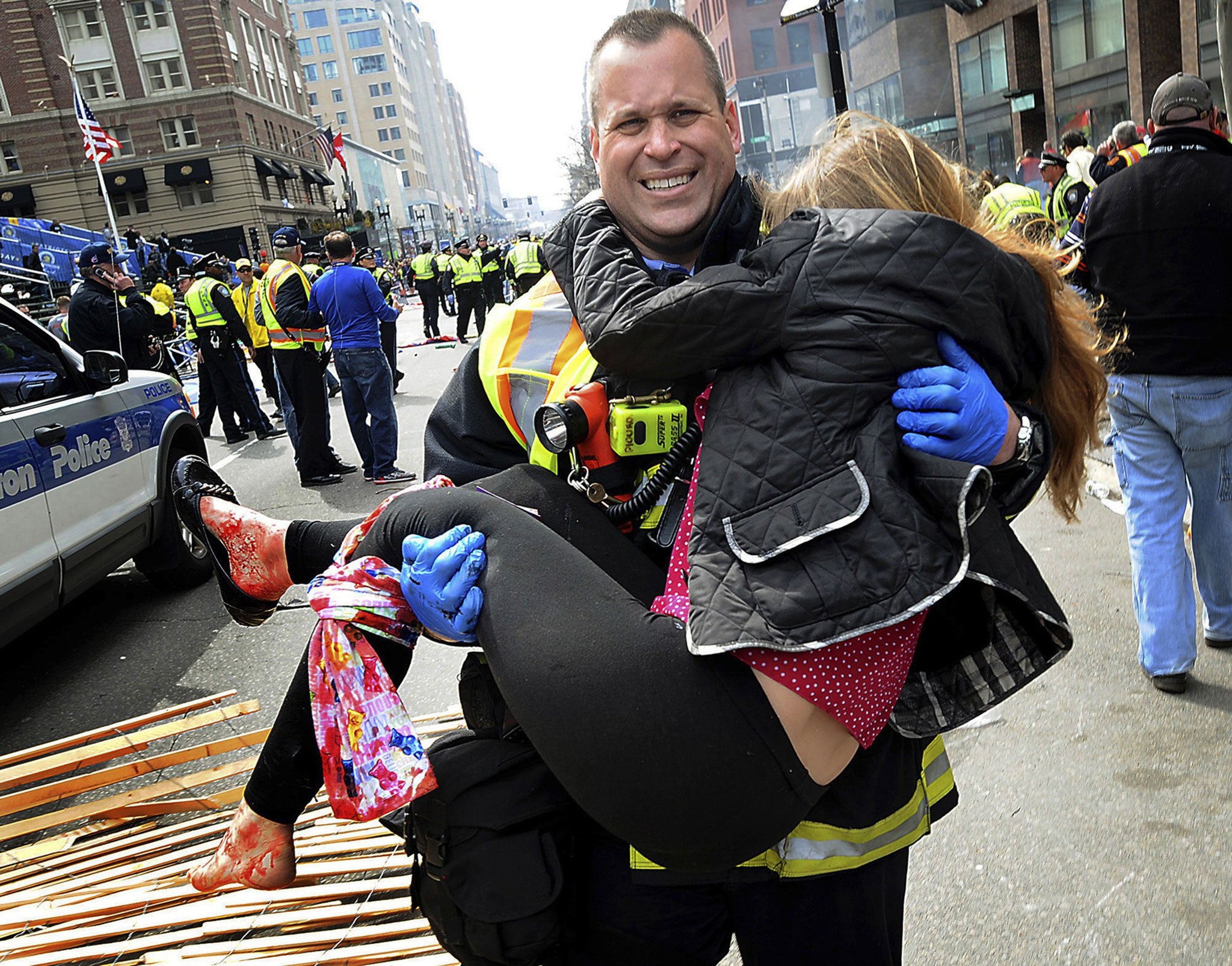 Boston firefighter James Plourde carries Victoria McGrath from the scene of the bombing in April 2013