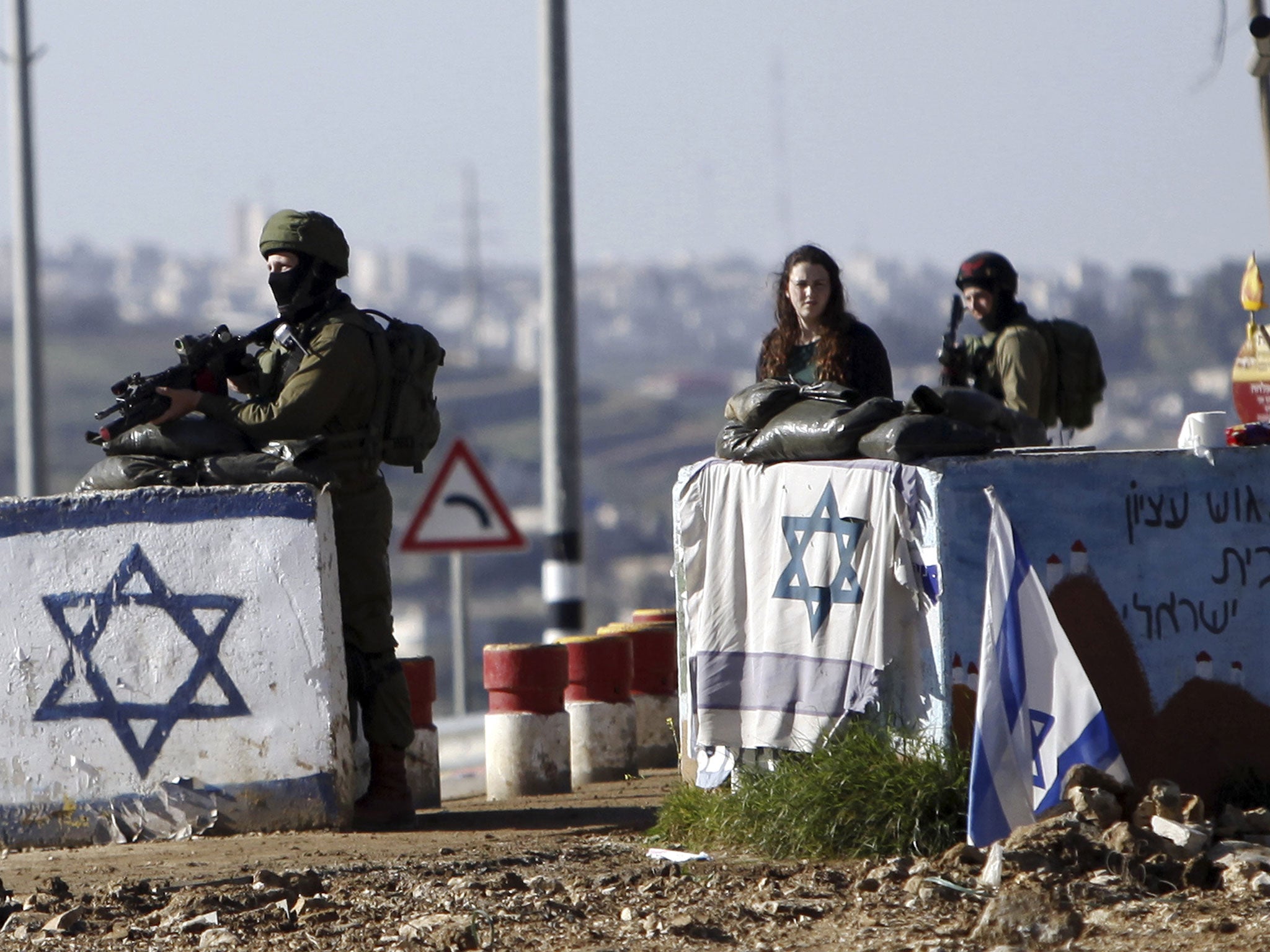 Israeli soldiers stand guard at Gush Etzion junction in the West Bank Friday, March 4, 2016, after a Palestinian woman allegedly tried to run over a soldier with her car.