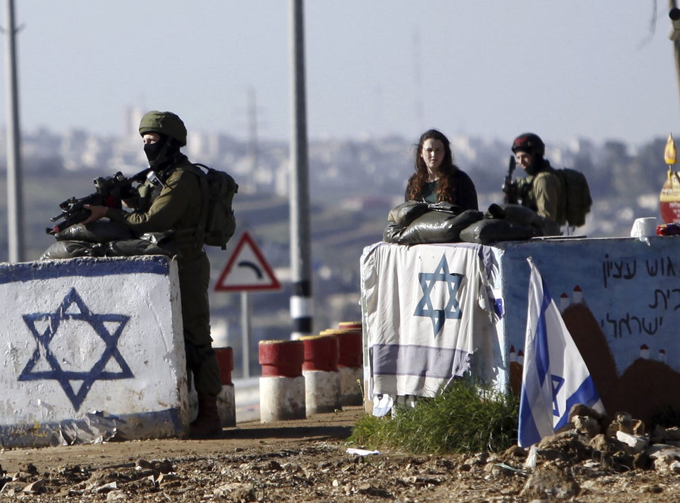 Israeli soldiers stand guard at Gush Etzion junction in the West Bank Friday, March 4, 2016, after a Palestinian woman allegedly tried to run over a soldier with her car.
