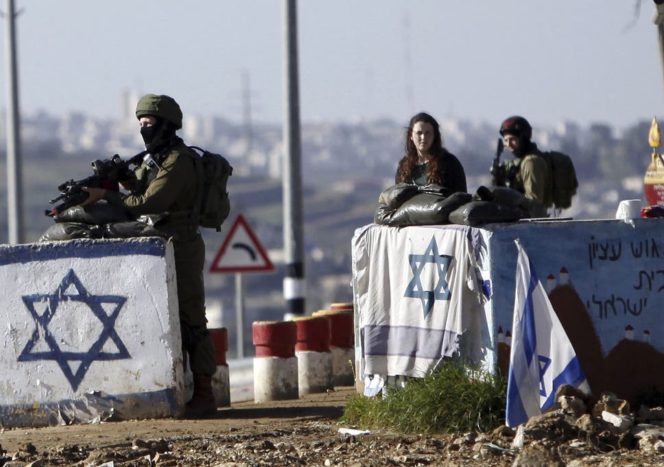 Israeli soldiers stand guard at Gush Etzion junction in the West Bank Friday, March 4, 2016, after a Palestinian woman allegedly tried to run over a soldier with her car. 