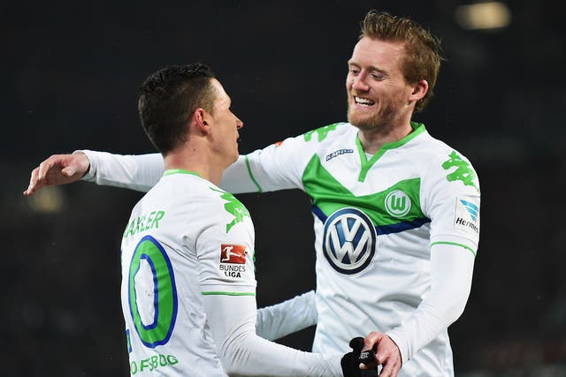Wolfsburg forward Andre Schurrle celebrates with team-mate Julian Draxler