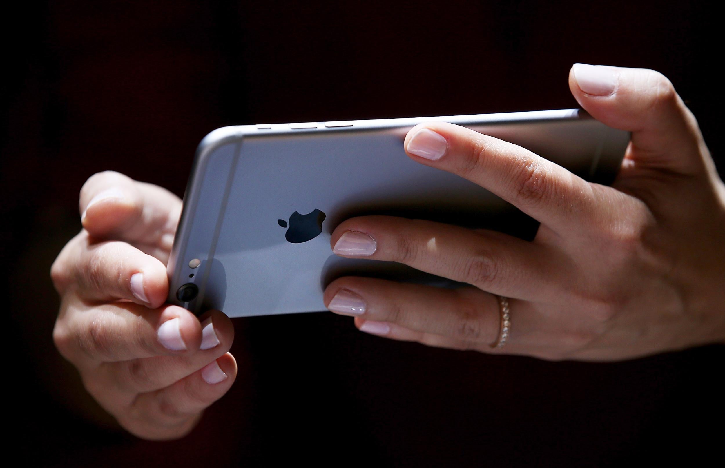 A member of the press uses the iPhone 6 at its launch event on September 9, 2014