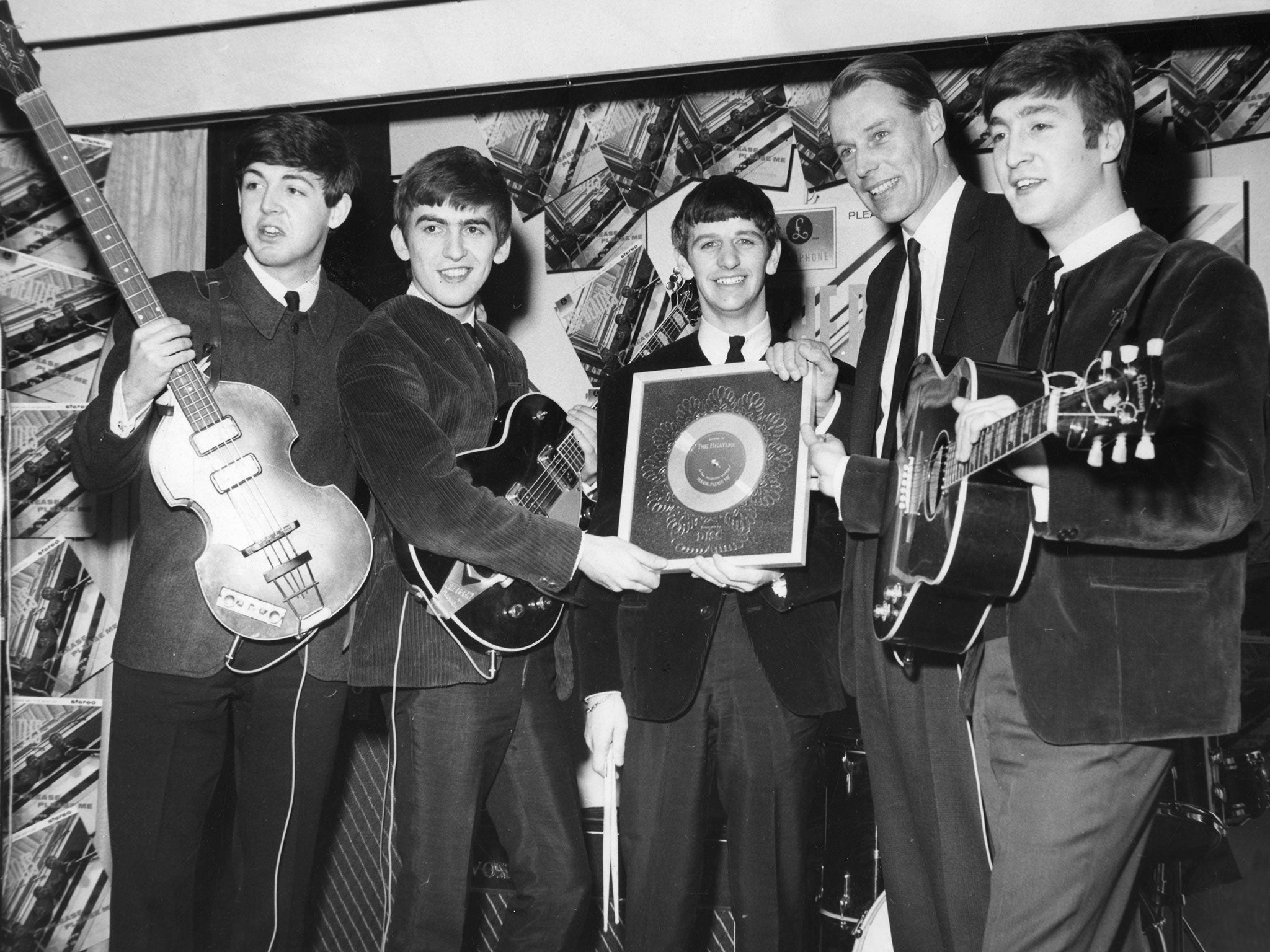 The Beatles receive a silver disc from Sir George Martin in 1963