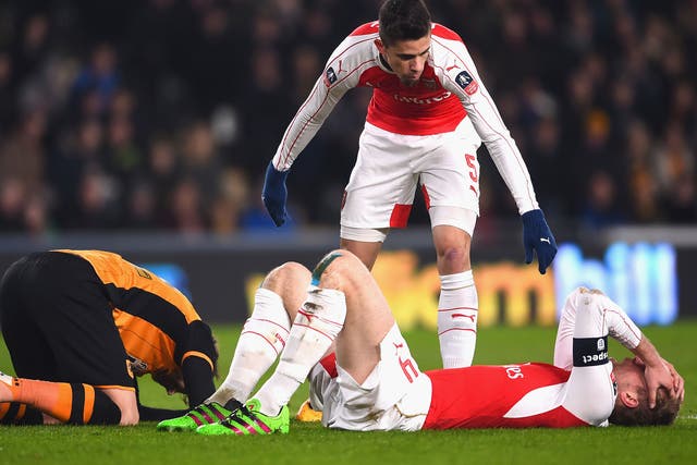Per Mertesacker suffered a cut and a small concussion after a head clash with Nick Powell