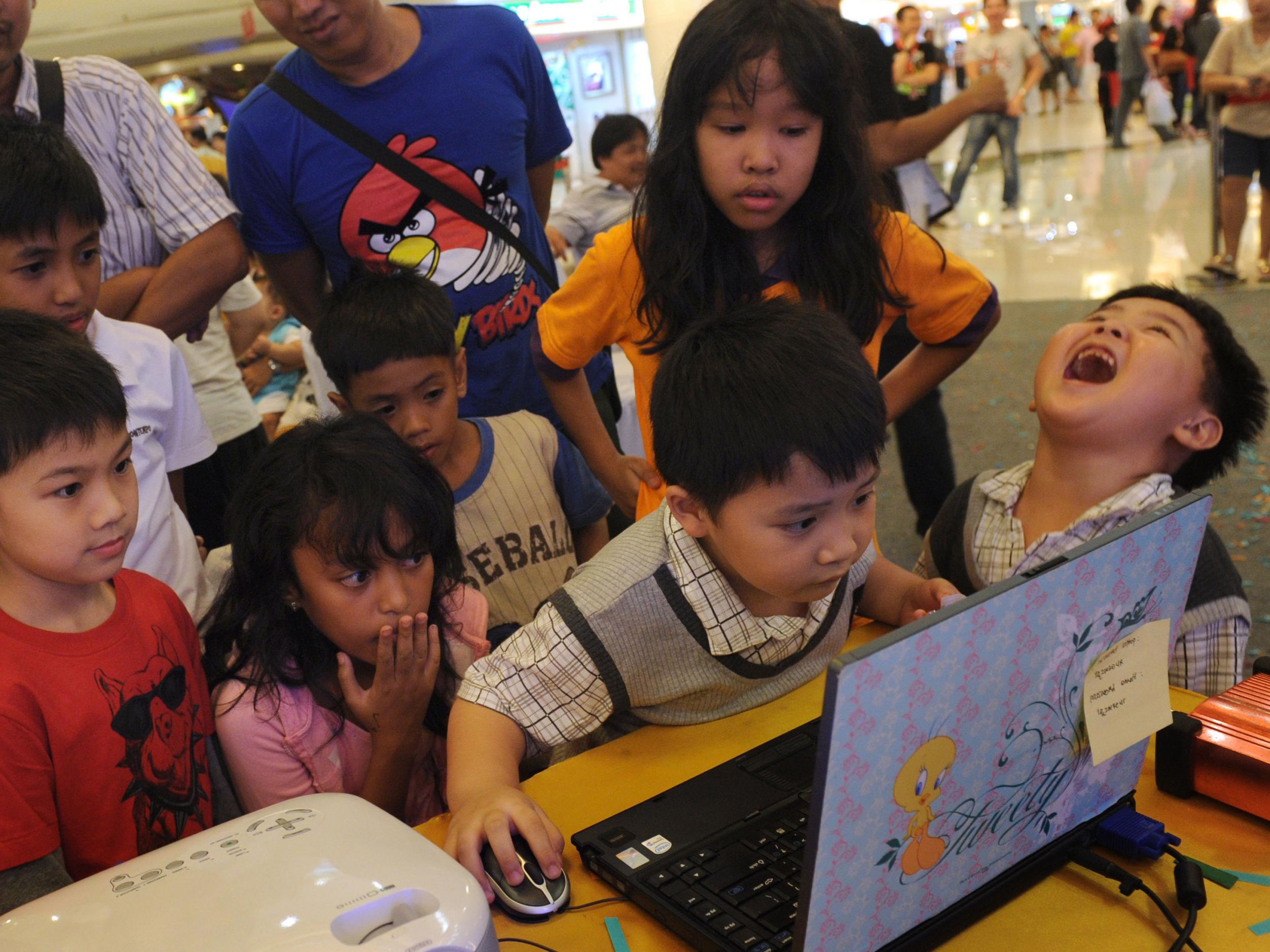 Children play Angry Birds on a laptop in an Indonesian shopping centre in 2012