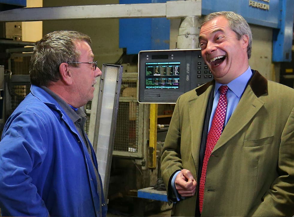 Nigel Farage laughs as he talks to staff members during a tour of a Manchester metal factory, March 23, 2015