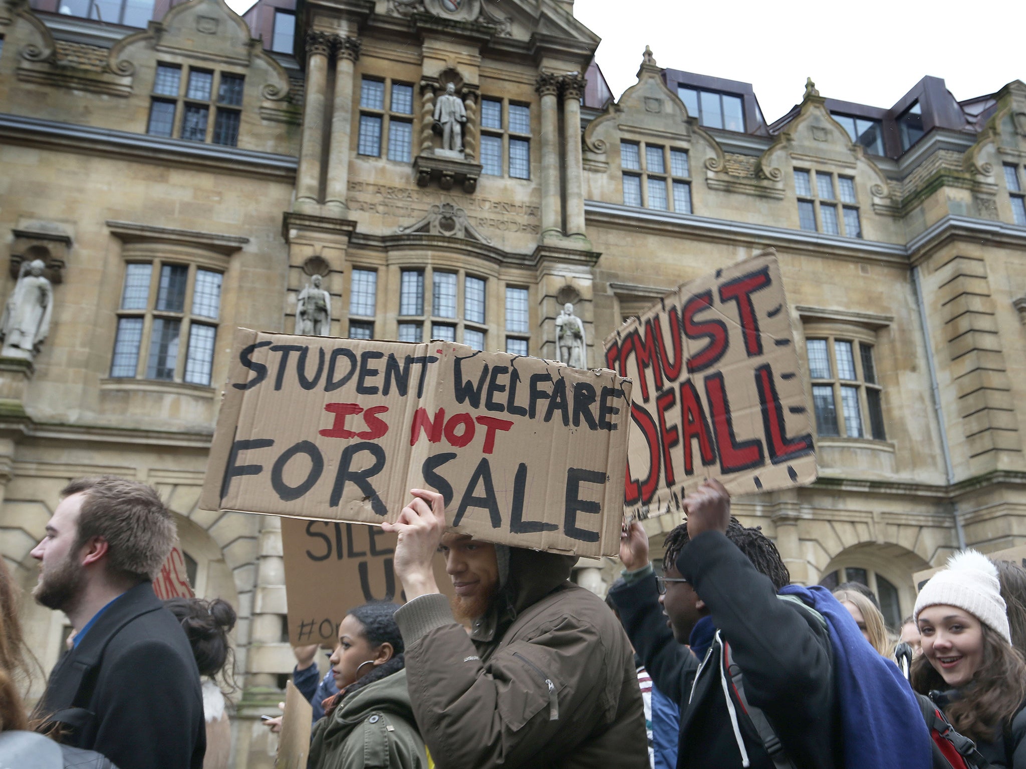 Protestors walking past the statue of Imperialist mining magnate Cecil Rhodes outside Oriel College, Oxford