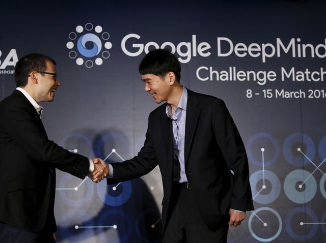 South Korea’s Lee Sedol (R), the world’s top Go player, shakes hands with Demis Hassabis, the CEO of DeepMind Technologies and developer of AlphaGO, after a news conference ahead of matches against Google’s artificial intelligence program AlphaGo