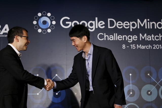 South Korea’s Lee Sedol (R), the world’s top Go player, shakes hands with Demis Hassabis, the CEO of DeepMind Technologies and developer of AlphaGO, after a news conference ahead of matches against Google’s artificial intelligence program AlphaGo