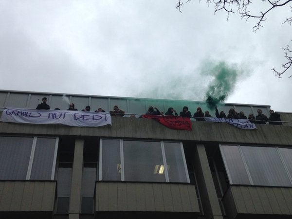 Occupiers, pictured, on the balcony of Bramber House and flying banners while chanting: 'Don’t Deport Luqman'