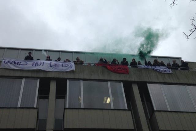 Occupiers, pictured, on the balcony of Bramber House and flying banners while chanting: 'Don’t Deport Luqman'