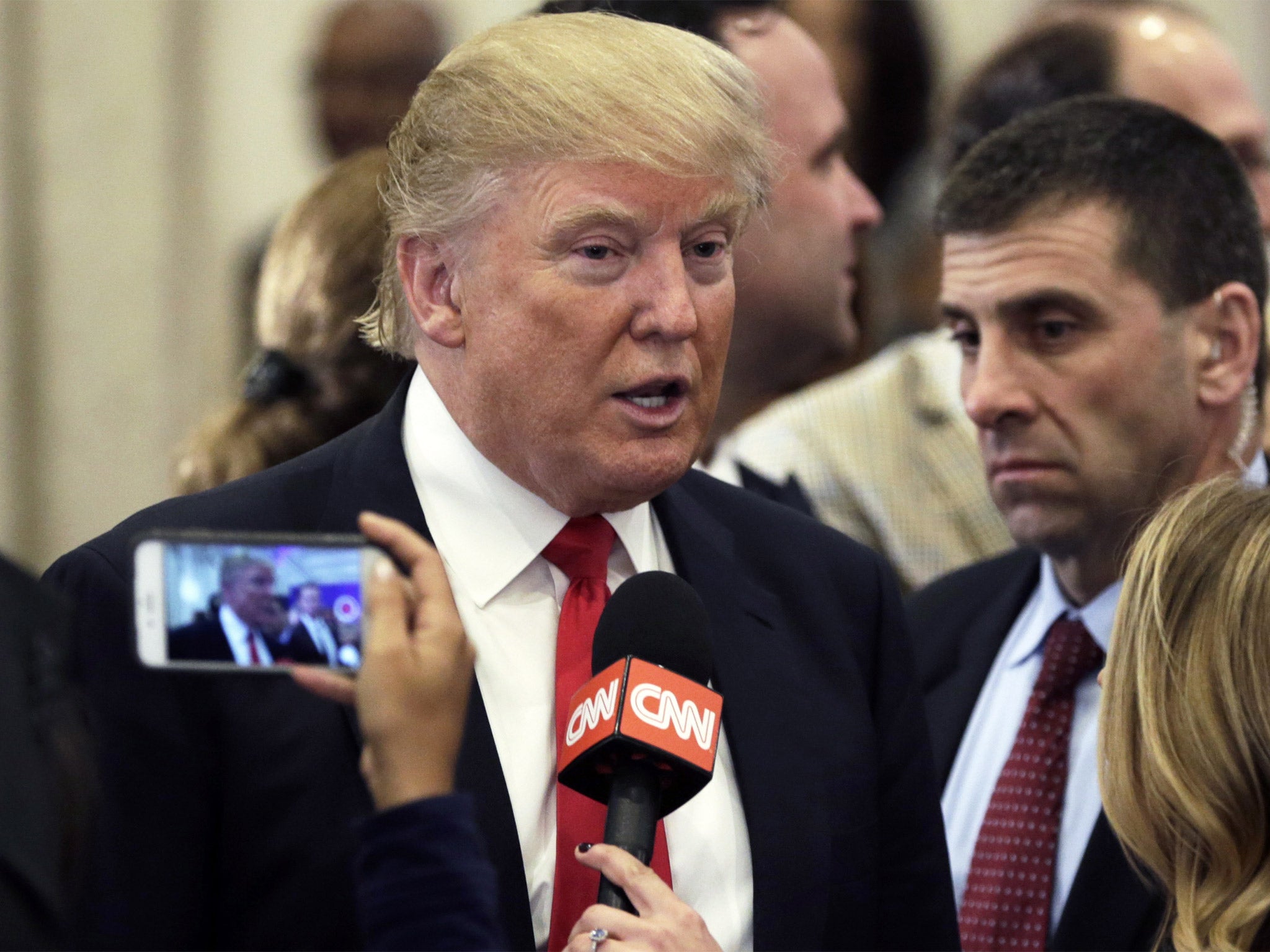 Donald Trump talks to media at his golf resort in Jupiter, Florida