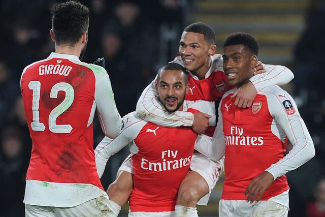 Arsenal players celebrate their third goal, scored by Theo Walcott, on Tuesday night