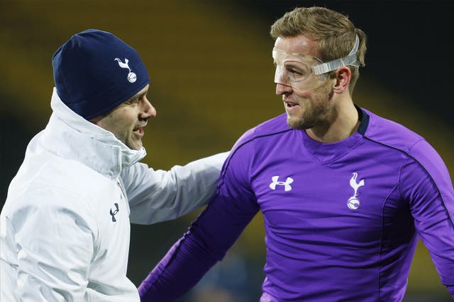 Manager Mauricio Pochettino, pictured with Harry Kane, will be in charge of his 100th competitive game for Spurs