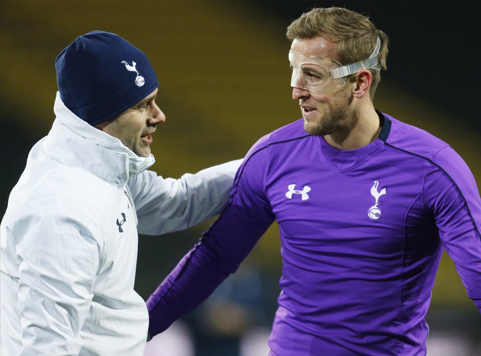 Manager Mauricio Pochettino, pictured with Harry Kane, will be in charge of his 100th competitive game for Spurs