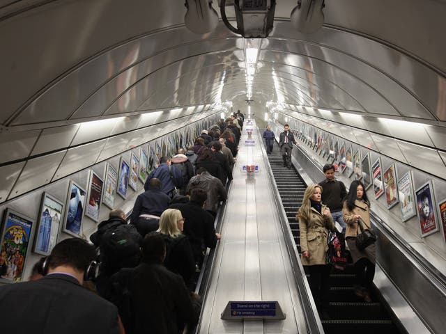 Commuters make their way on the escalator at Angel underground station, which is 27.4m long. Escalators at Holborn are 23.4m long