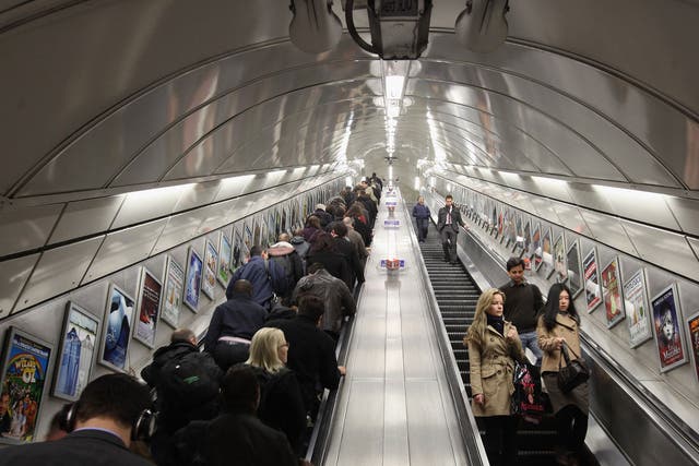 Commuters make their way on the escalator at Angel underground station, which is 27.4m long. Escalators at Holborn are 23.4m long