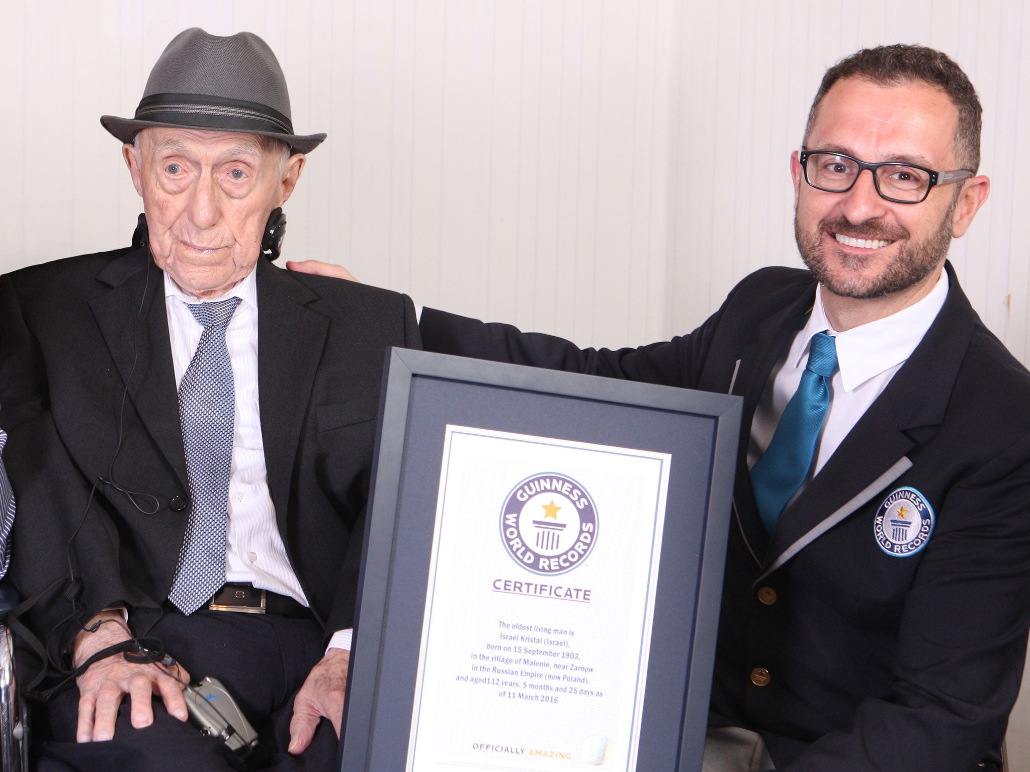 Yisrael Kristal, who has died at the age of 13, receiving his certificate on becoming the world's oldest man last year