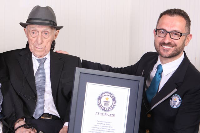 Yisrael Kristal, who has died at the age of 13, receiving his certificate on becoming the world's oldest man last year