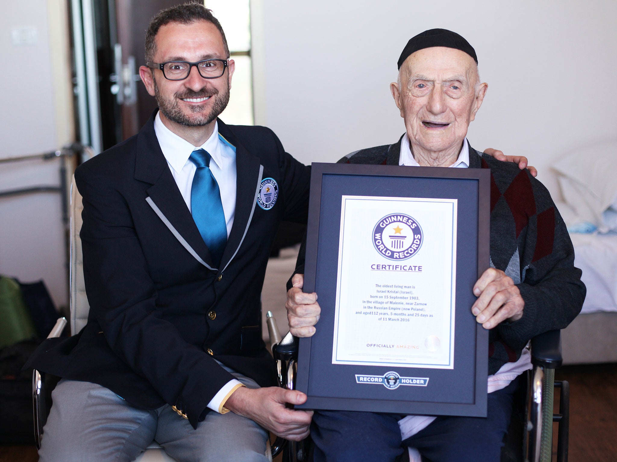 Israel Kristal, 113, receives his certificate from Marco Frigatti, Guinness World Records Head of Records, in March 2016