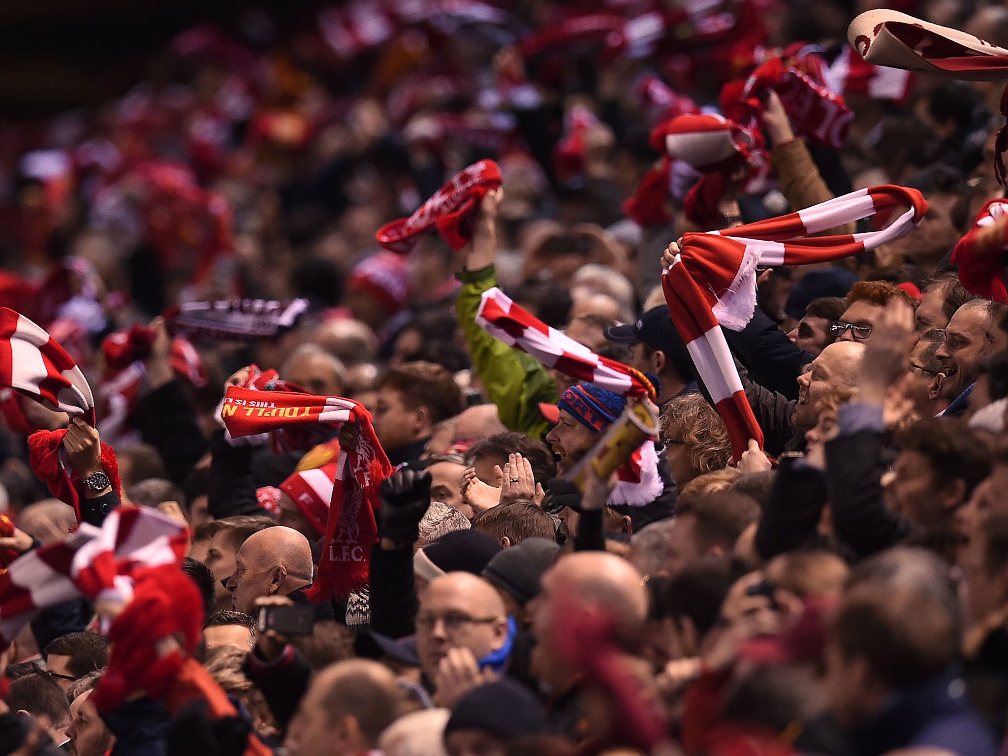 Liverpool supporters wave scarves during Thursday's victory over Manchester United