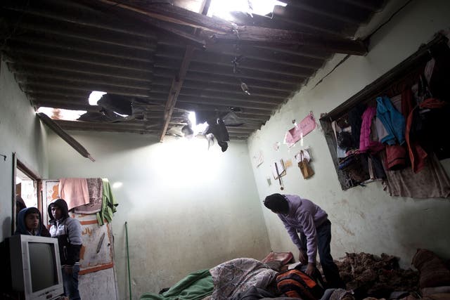 A Palestinian boy inspects a bedroom of the damaged Khoussa family home after an Israeli strike on Hamas bases in Beit Lahiya, northern Gaza strip