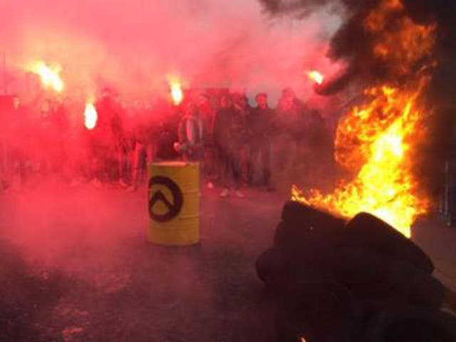 Generation Identitaire activists burned tyres and set off flares before the demonstration was dismantled by police on 12 March