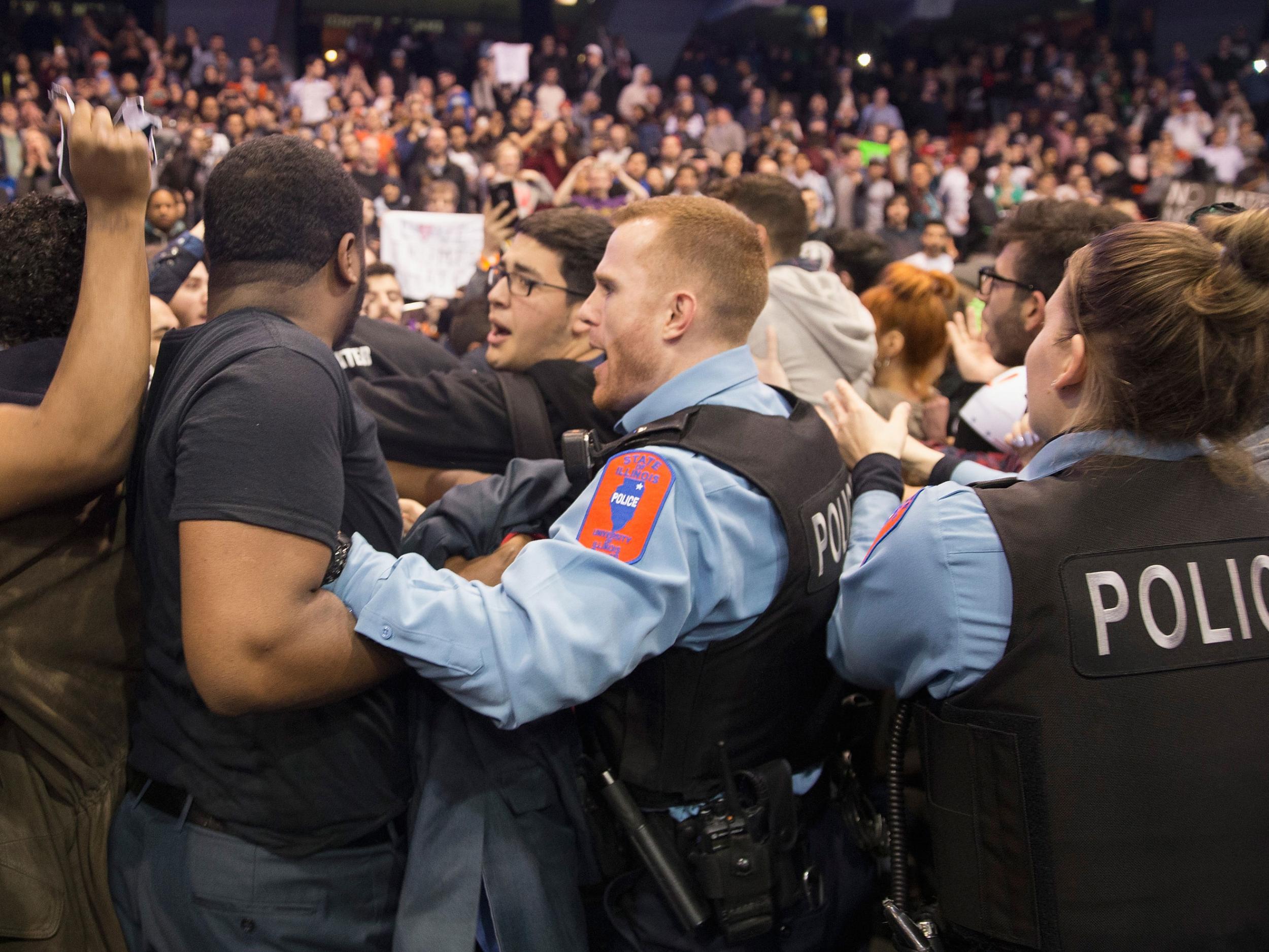 Police break up skirmishes between demonstrators and supporters of Republican presidential candidate Donald Trump