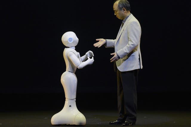 Electric dreams: SoftBank CEO Masayoshi Son interacts with humanoid robot ‘Pepper’  EPA