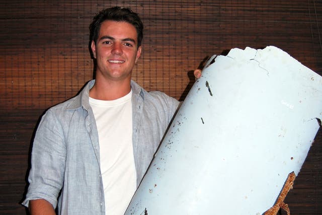 Liam Lotter poses with a piece of debris thought to be part of the missing Malaysia Airlines Flight MH370