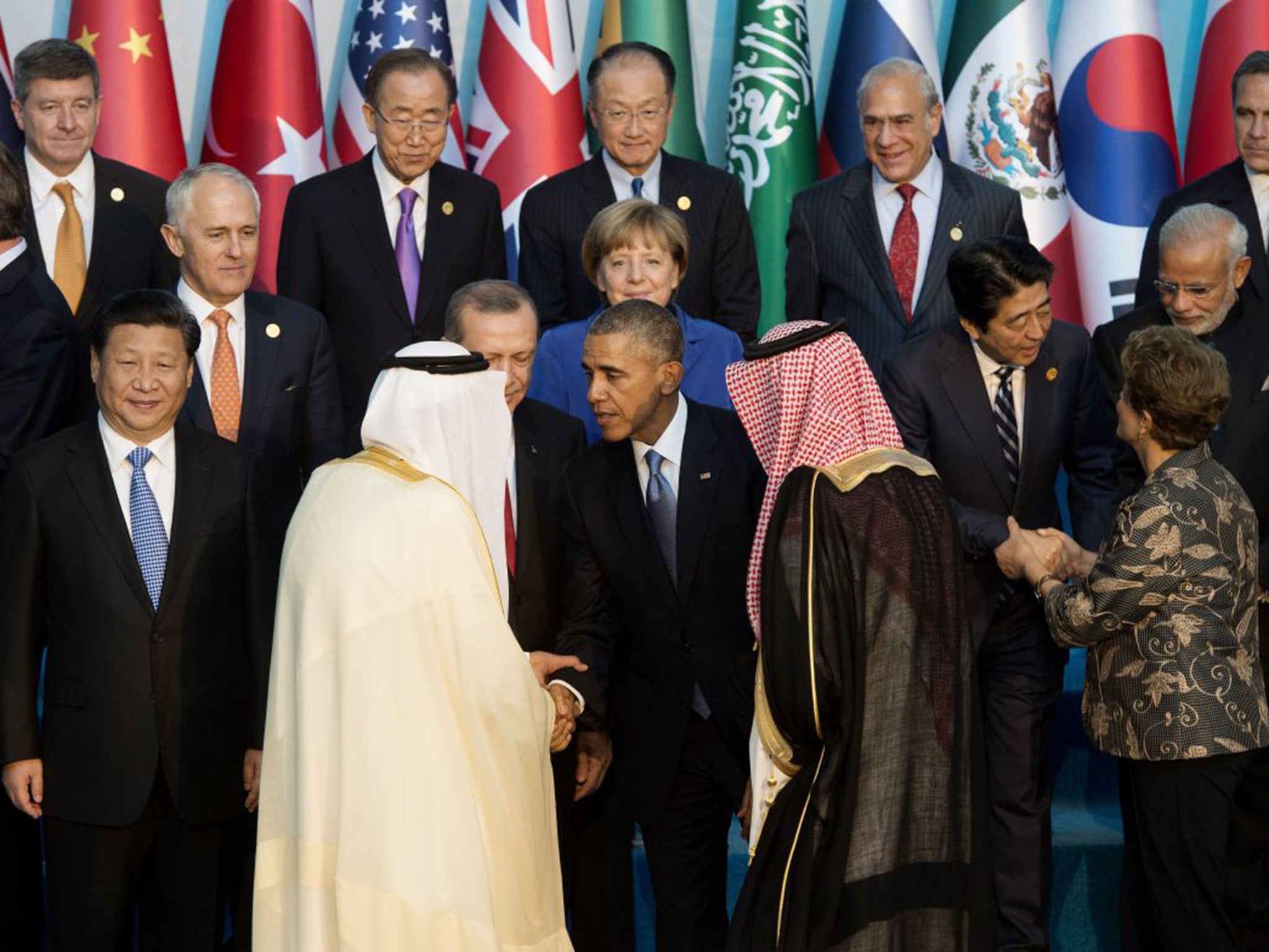 Barack Obama speaks with Saudi Arabia's King Salman, left, as they arrive for the official family photo during the G20 summit in Antalya, Turkey, last year