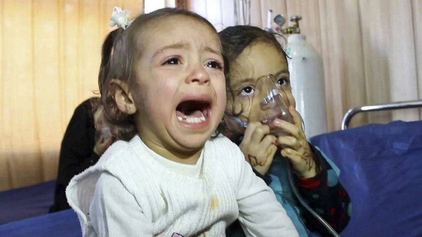 Young victims exposed to a chemical attack wait for treatment at a hospital in Taza