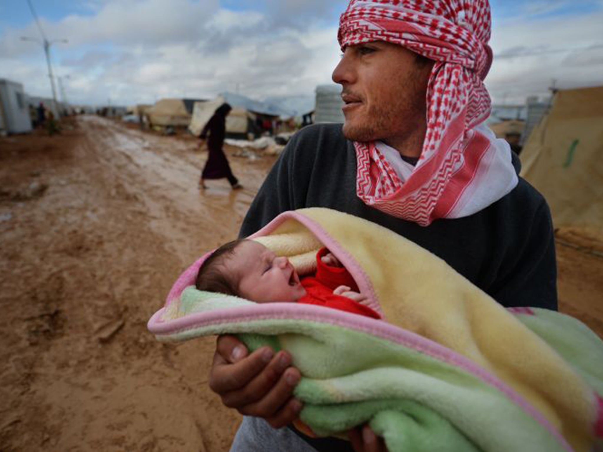 &#13;
A Syrian man holds a newborn child &#13;