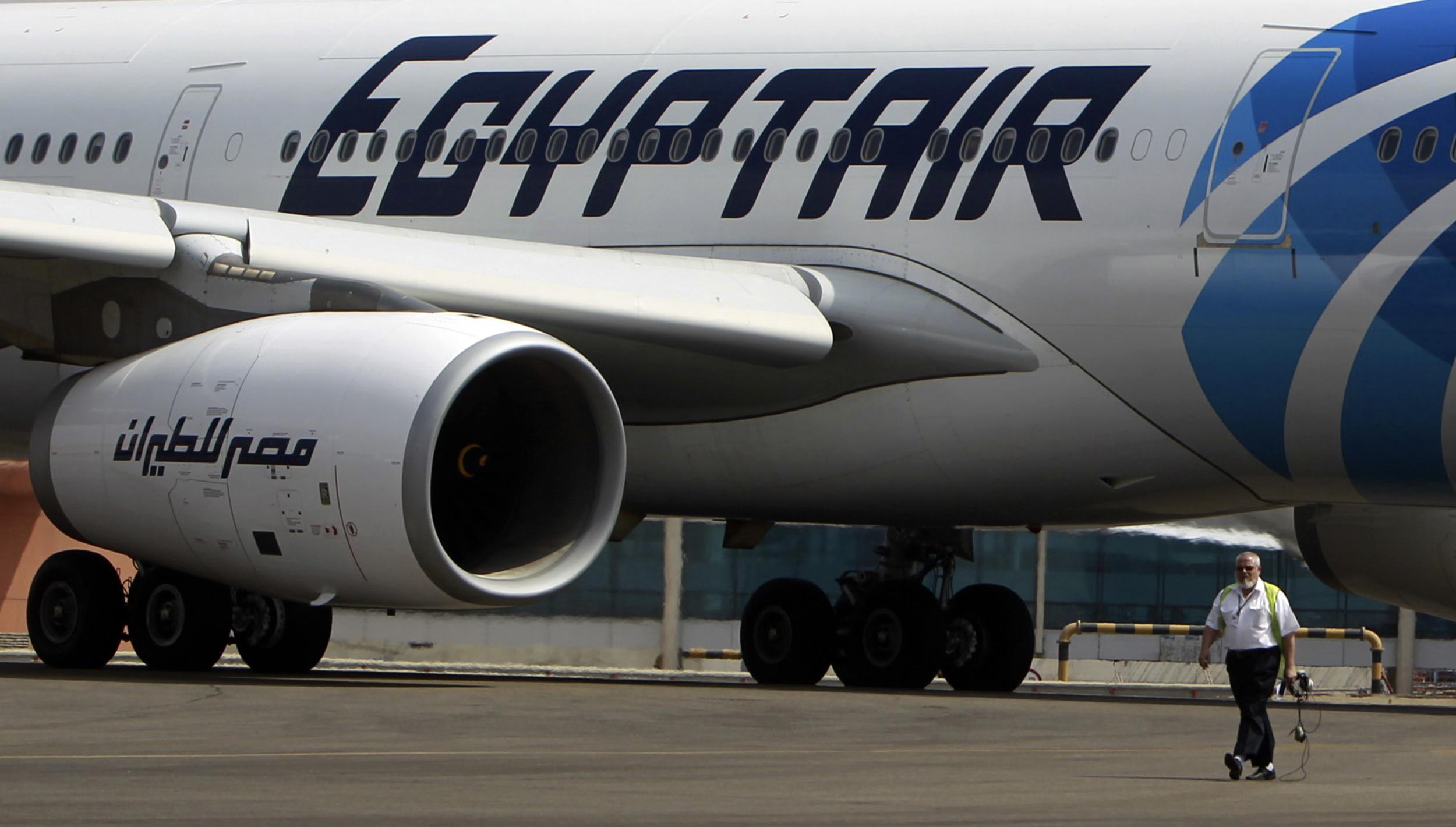 (File photo) An airport staff walks next to an EgyptAir plane on the runway at Cairo Airport