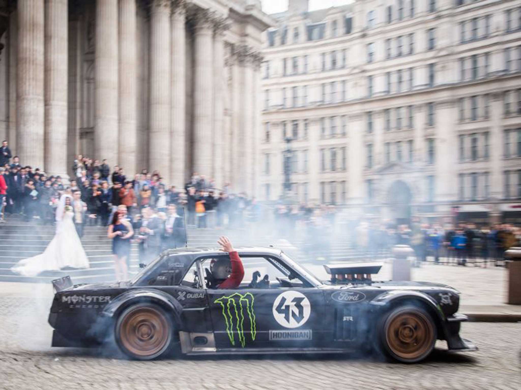 Top Gear host Matt LeBlanc waving to a bride and groom at St Paul's Cathedral in London