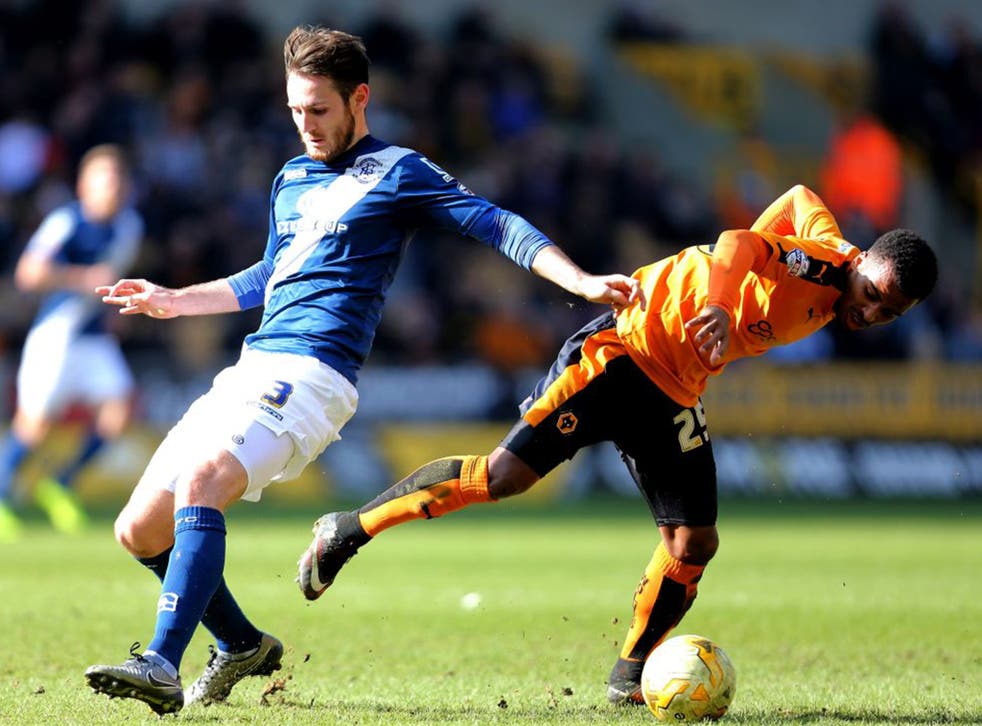 Birmingham City's Jonathan Grounds and Wolverhampton Wanderers's Nathan Byrne compete for the ball
