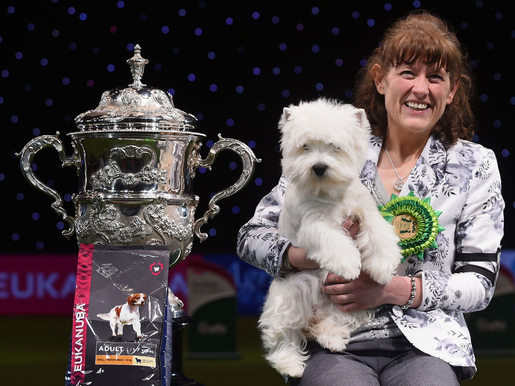 Devon the West Highland Terrier with handler Marie Burns who has been named Best in Show at Crufts 2016 at the NEC, Birmingham