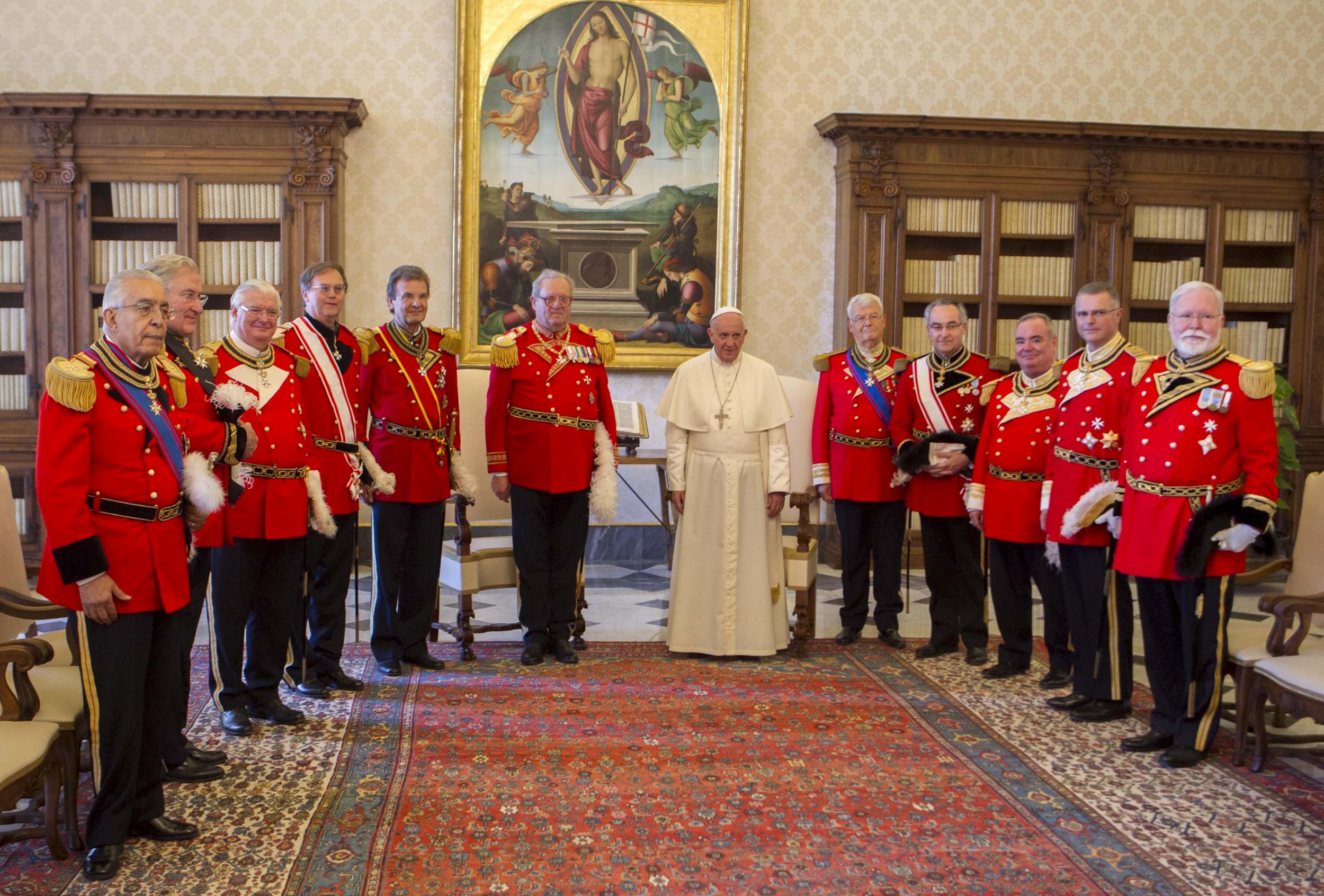 Pope Francis poses with the Grand Master of the Sovereign Order of Malta, Fra' Matthew Festing (6th L) and delegates