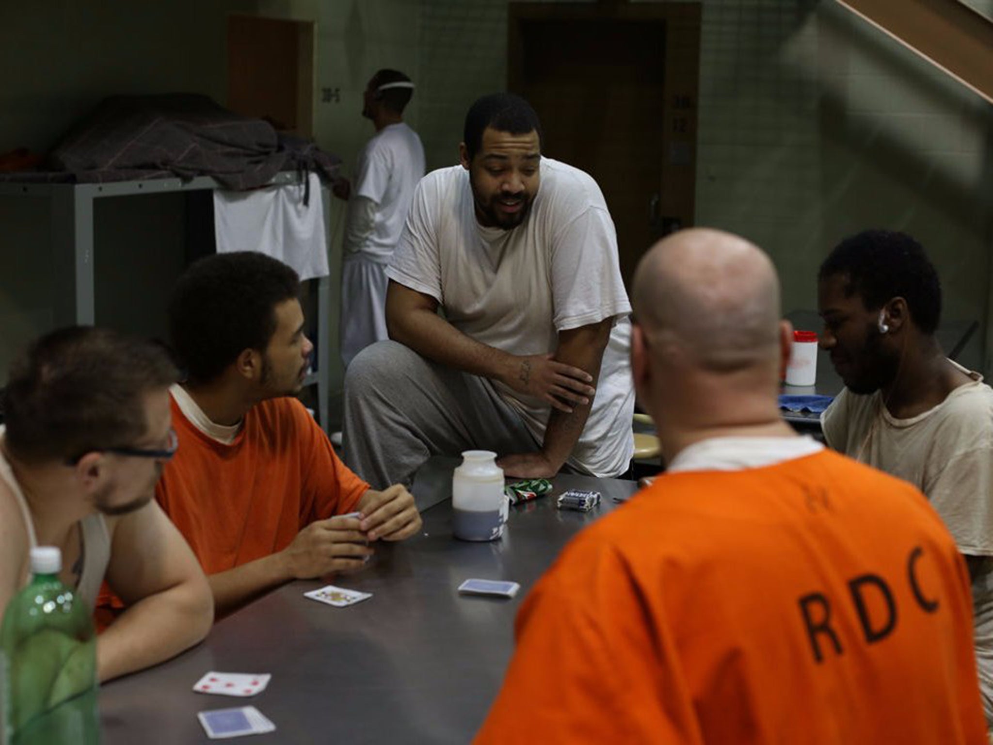 Zac (left) and Isaiah (right), two undercover participants on "60 Days In," sit among a group of inmates